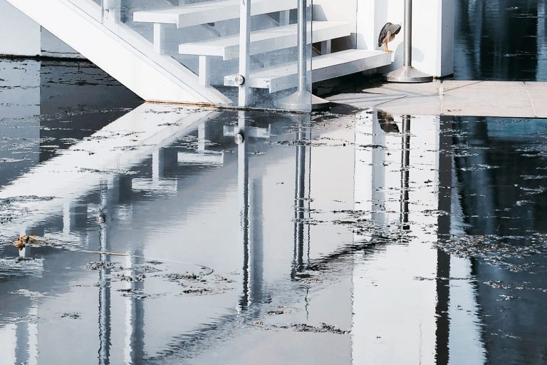 Floodwater covering a floor at the foot of a staircase